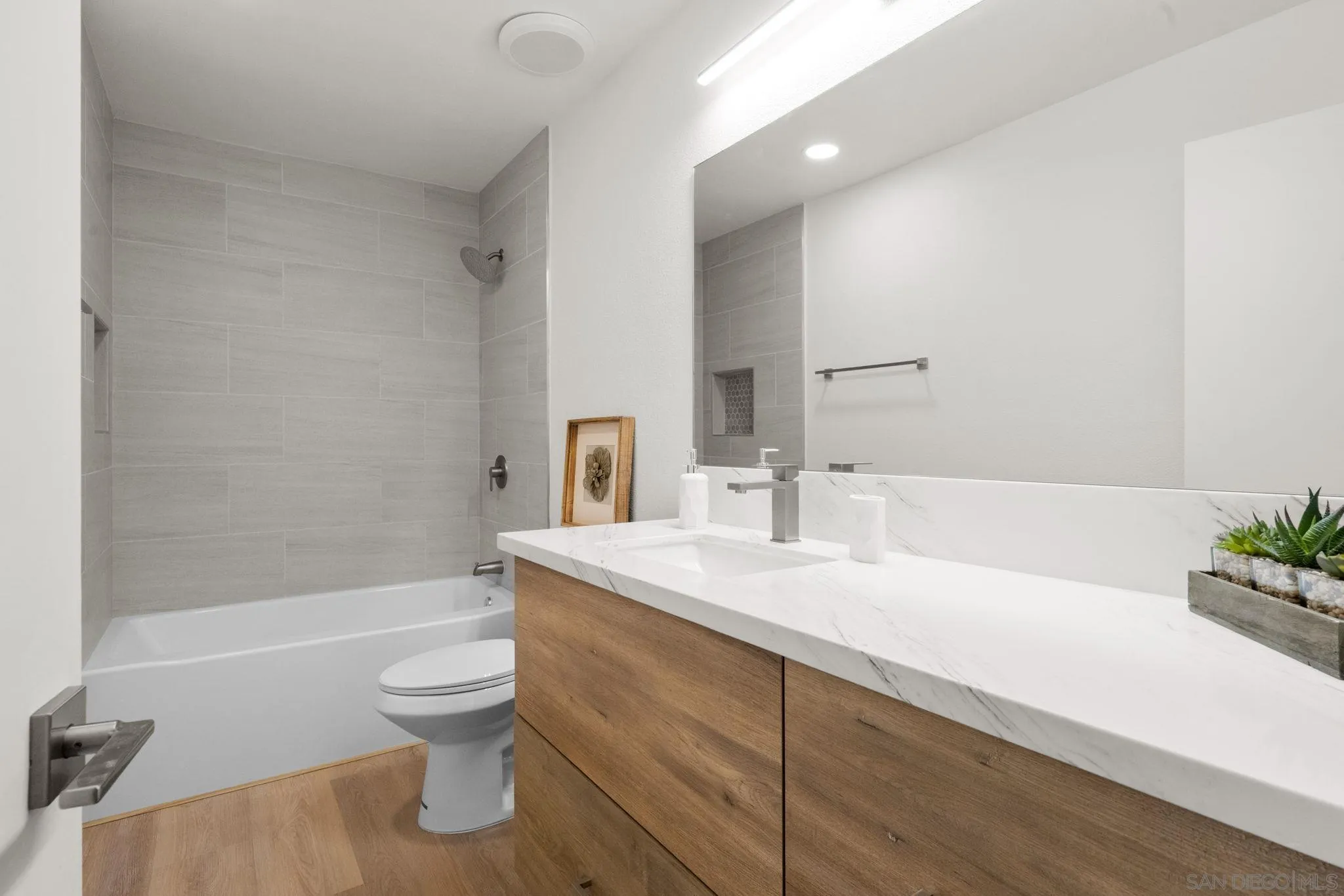 5700 Baltimore Drive La Mesa, CA 91942 - Photo 24 of 37 a bathroom with a sink a toilet and bathtub