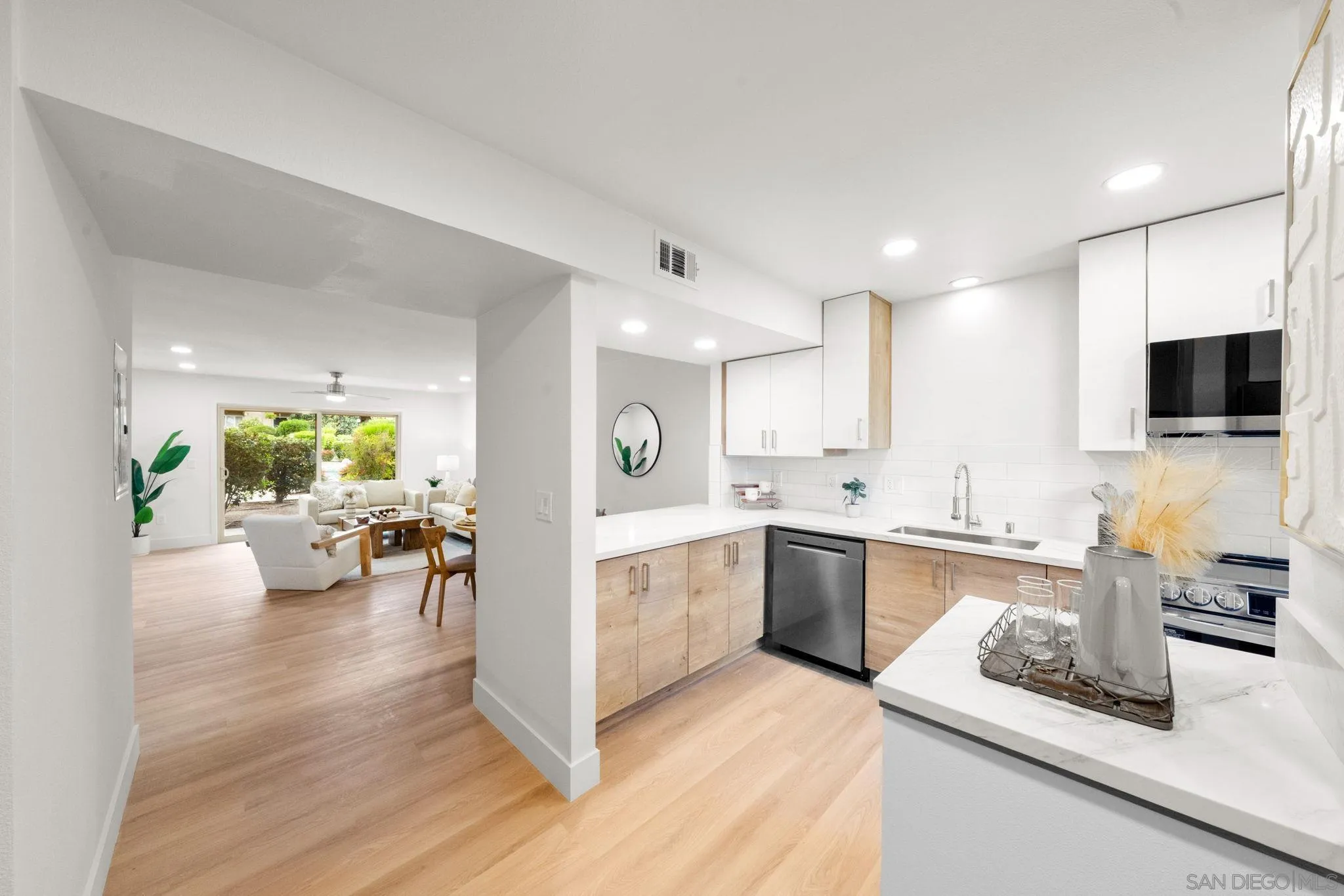 5700 Baltimore Drive La Mesa, CA 91942 - Photo 3 of 37 a view of a kitchen with kitchen island wooden floor center island and stainless steel appliances