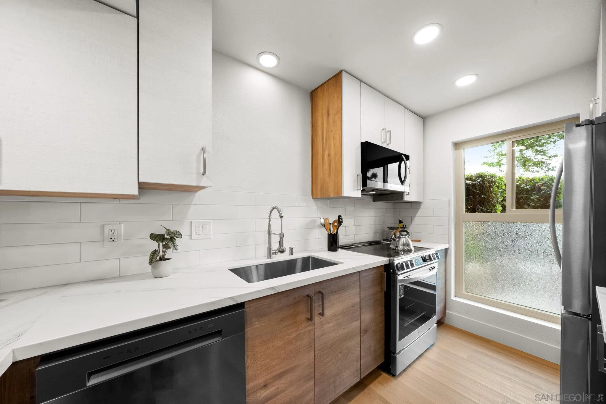 5700 Baltimore Drive La Mesa, CA 91942 - Photo 4 of 37 a kitchen with a sink stove and microwave