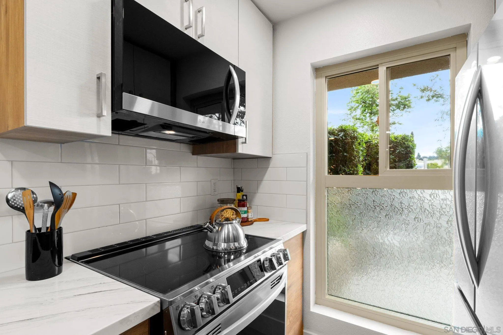 5700 Baltimore Drive La Mesa, CA 91942 - Photo 5 of 37 a kitchen with a stove and a microwave