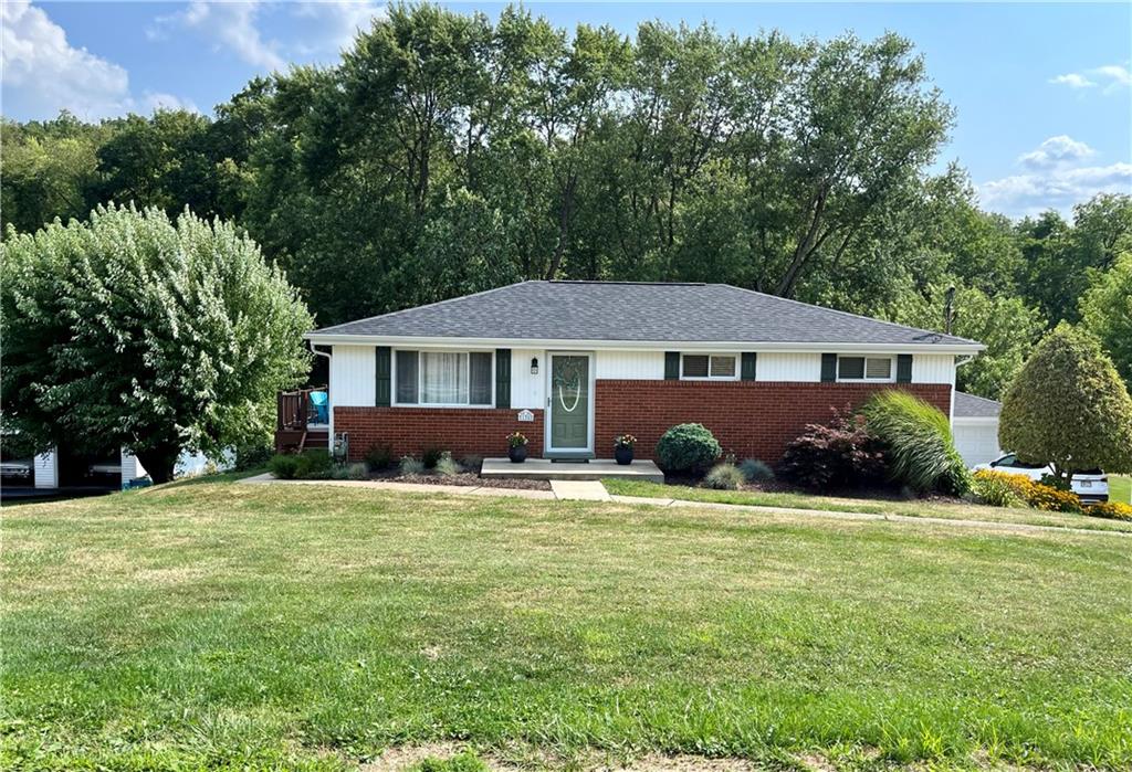 135 Lagonda Road Washington, PA 15301 - Photo 1 of 25 a front view of a house with a garden