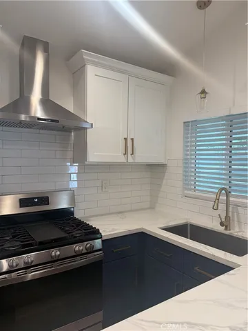 a kitchen with sink and cabinets