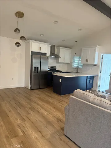 a kitchen with stainless steel appliances granite countertop a refrigerator sink and cabinets