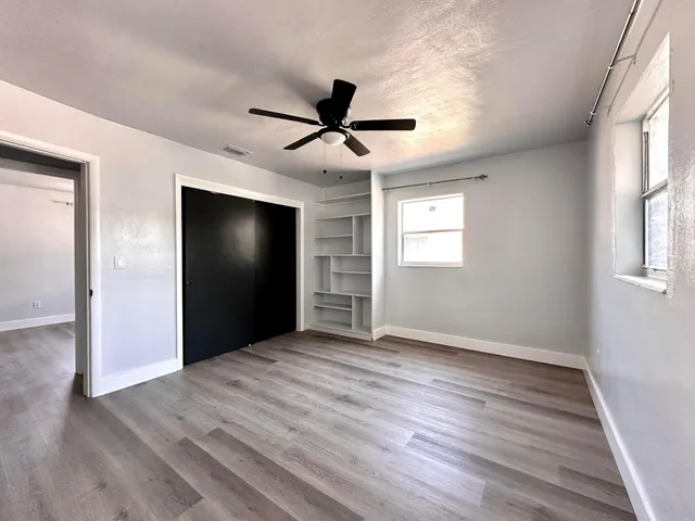 wooden floor in an empty room with a window