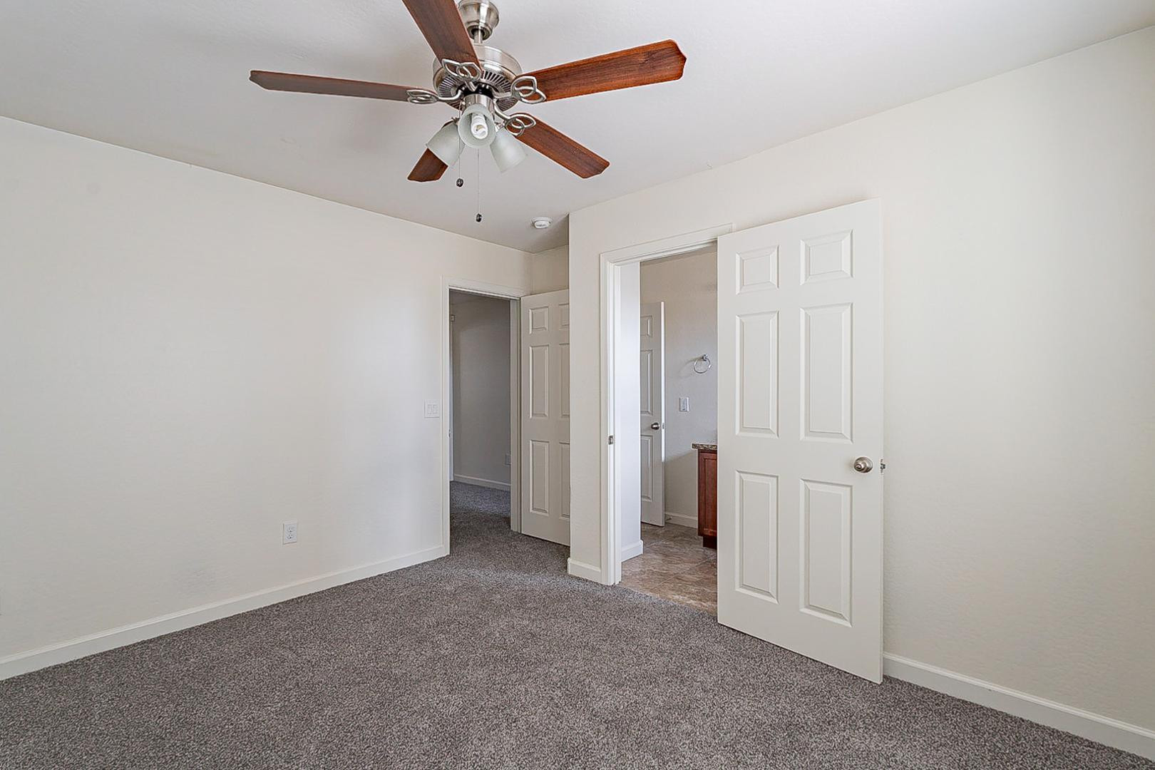 17223 North Cave Creek Road, Unit 7 Phoenix, AZ 85032 - Photo 13 of 23 an empty room with a ceiling fan and carpet