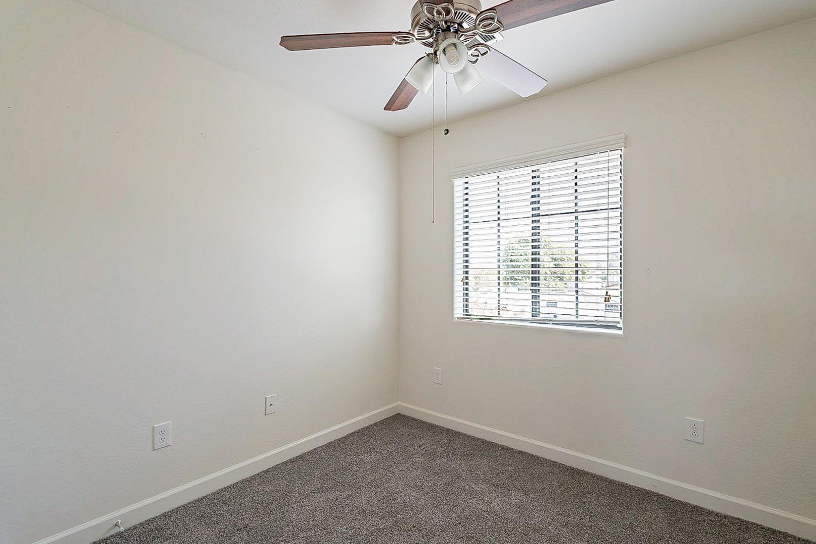 17223 North Cave Creek Road, Unit 7 Phoenix, AZ 85032 - Photo 15 of 23 an empty room with a window and a fan