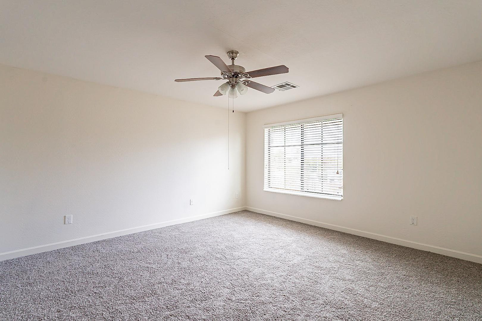 17223 North Cave Creek Road, Unit 7 Phoenix, AZ 85032 - Photo 17 of 23 a view of a livingroom with a ceiling fan and window
