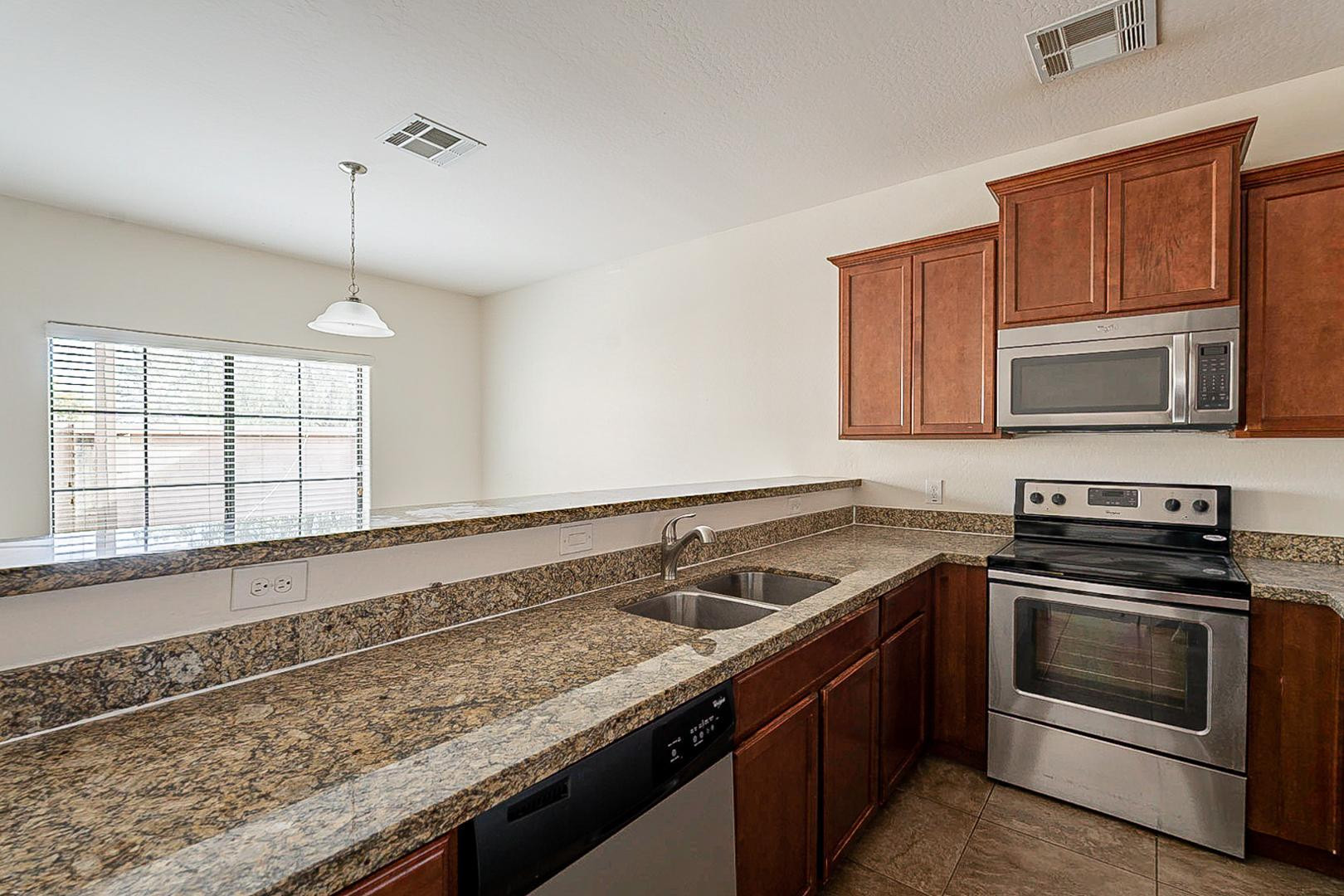 17223 North Cave Creek Road, Unit 7 Phoenix, AZ 85032 - Photo 6 of 23 a kitchen that has a sink and a stove