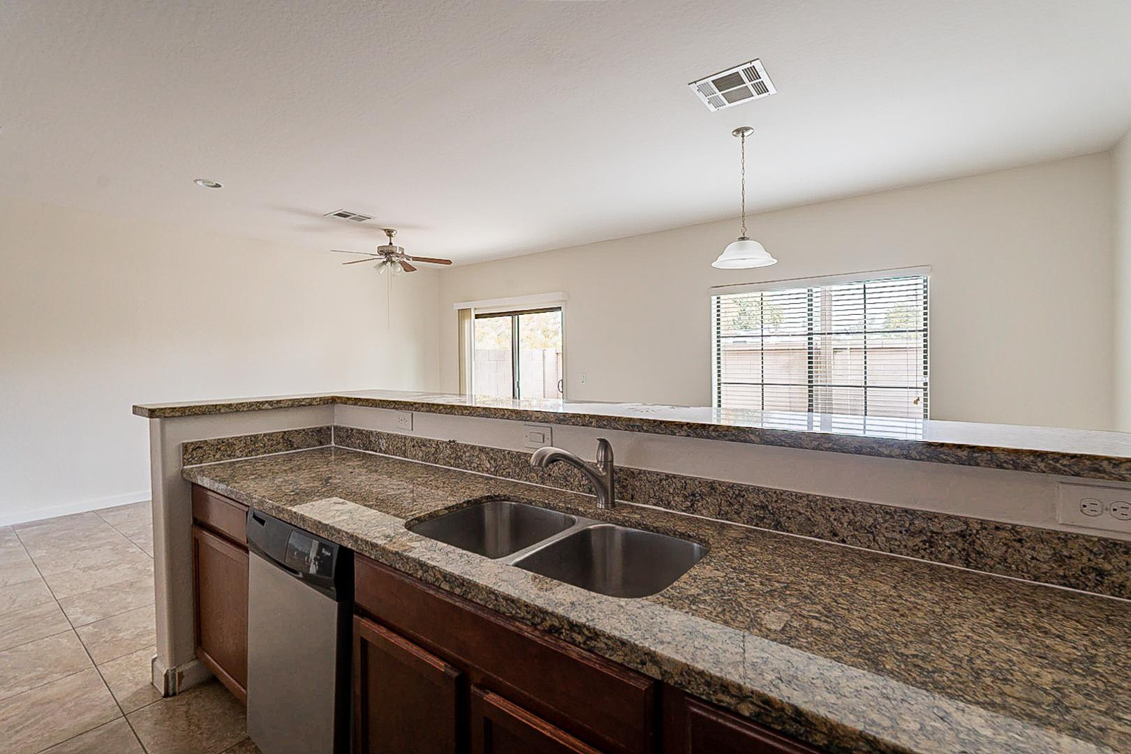 17223 North Cave Creek Road, Unit 7 Phoenix, AZ 85032 - Photo 8 of 23 a kitchen that has a sink stove and cabinets