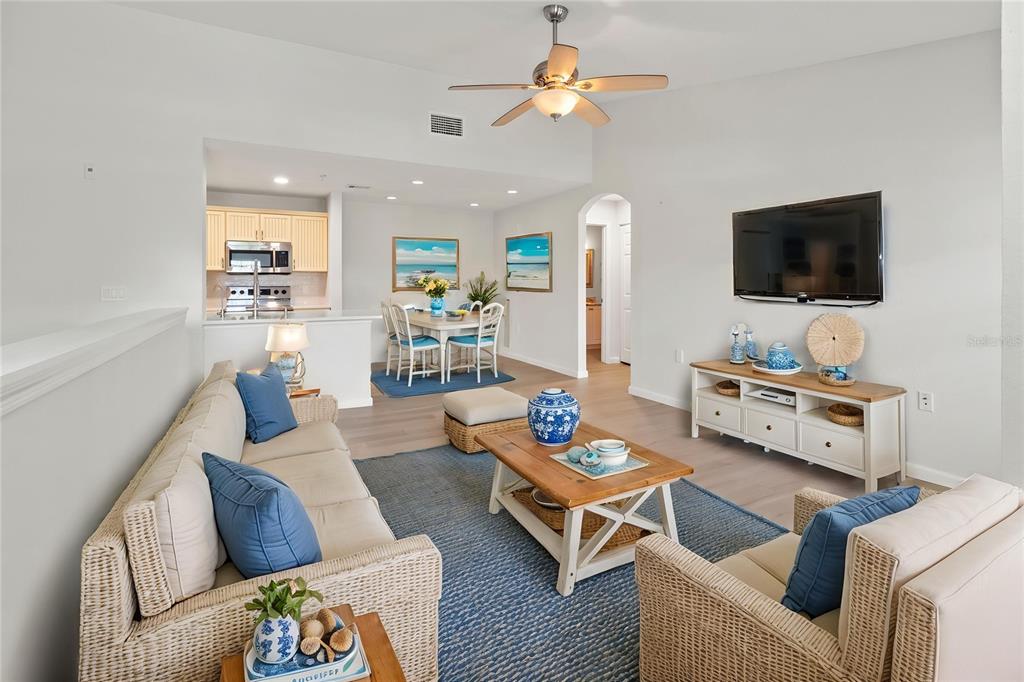 8827 Manor Loop, Unit 201 Lakewood Ranch, FL 34202 - Photo 12 of 41 a living room with furniture and a flat screen tv