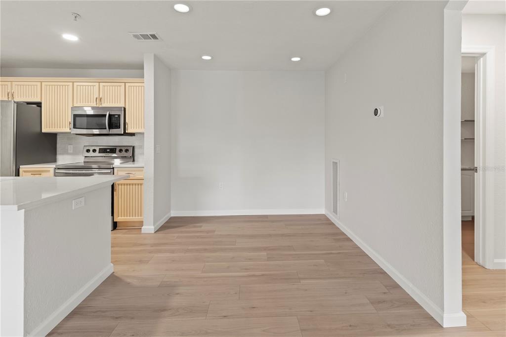 8827 Manor Loop, Unit 201 Lakewood Ranch, FL 34202 - Photo 13 of 39 a kitchen with stainless steel appliances a refrigerator and a stove top oven