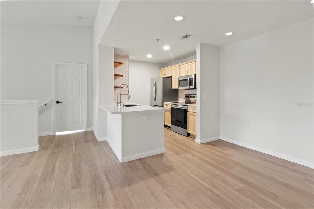8827 Manor Loop, Unit 201 Lakewood Ranch, FL 34202 - Photo 14 of 39 a view of a kitchen with wooden floor