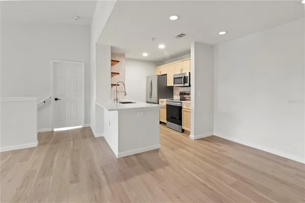 a view of a kitchen with wooden floor