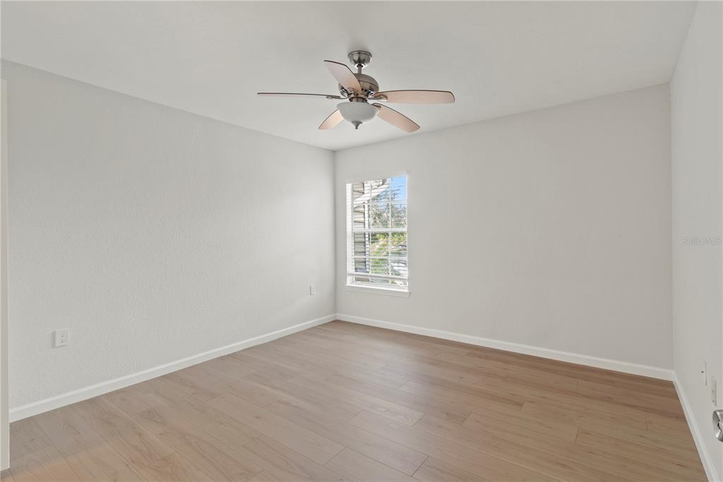 8827 Manor Loop, Unit 201 Lakewood Ranch, FL 34202 - Photo 18 of 41 wooden floor in an empty room