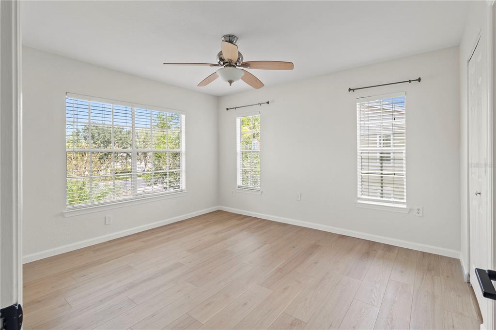 8827 Manor Loop, Unit 201 Lakewood Ranch, FL 34202 - Photo 27 of 39 a view of an empty room with a window and wooden floor