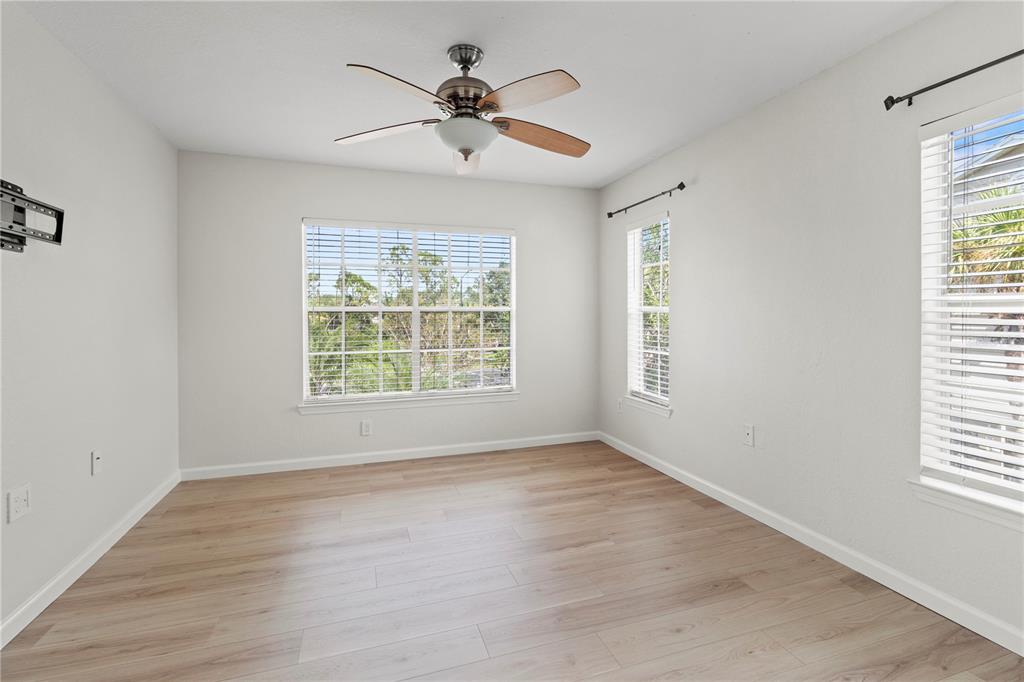 8827 Manor Loop, Unit 201 Lakewood Ranch, FL 34202 - Photo 28 of 39 a view of room with window ceiling fan and hardwood floor