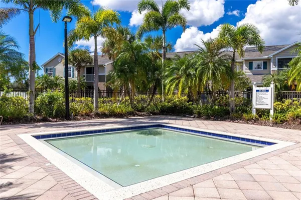 a view of a house with swimming pool and sitting area