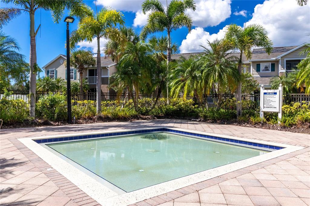 8827 Manor Loop, Unit 201 Lakewood Ranch, FL 34202 - Photo 39 of 41 a view of a house with swimming pool and sitting area