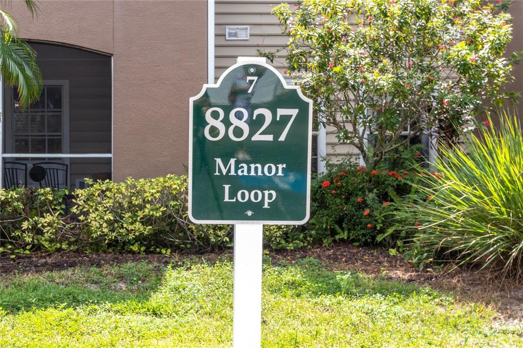 8827 Manor Loop, Unit 201 Lakewood Ranch, FL 34202 - Photo 8 of 39 a sign broad in front of the house