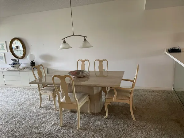 a dining room with furniture and a mirror