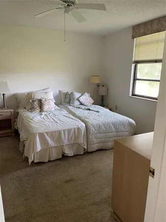 a bedroom with bed and window