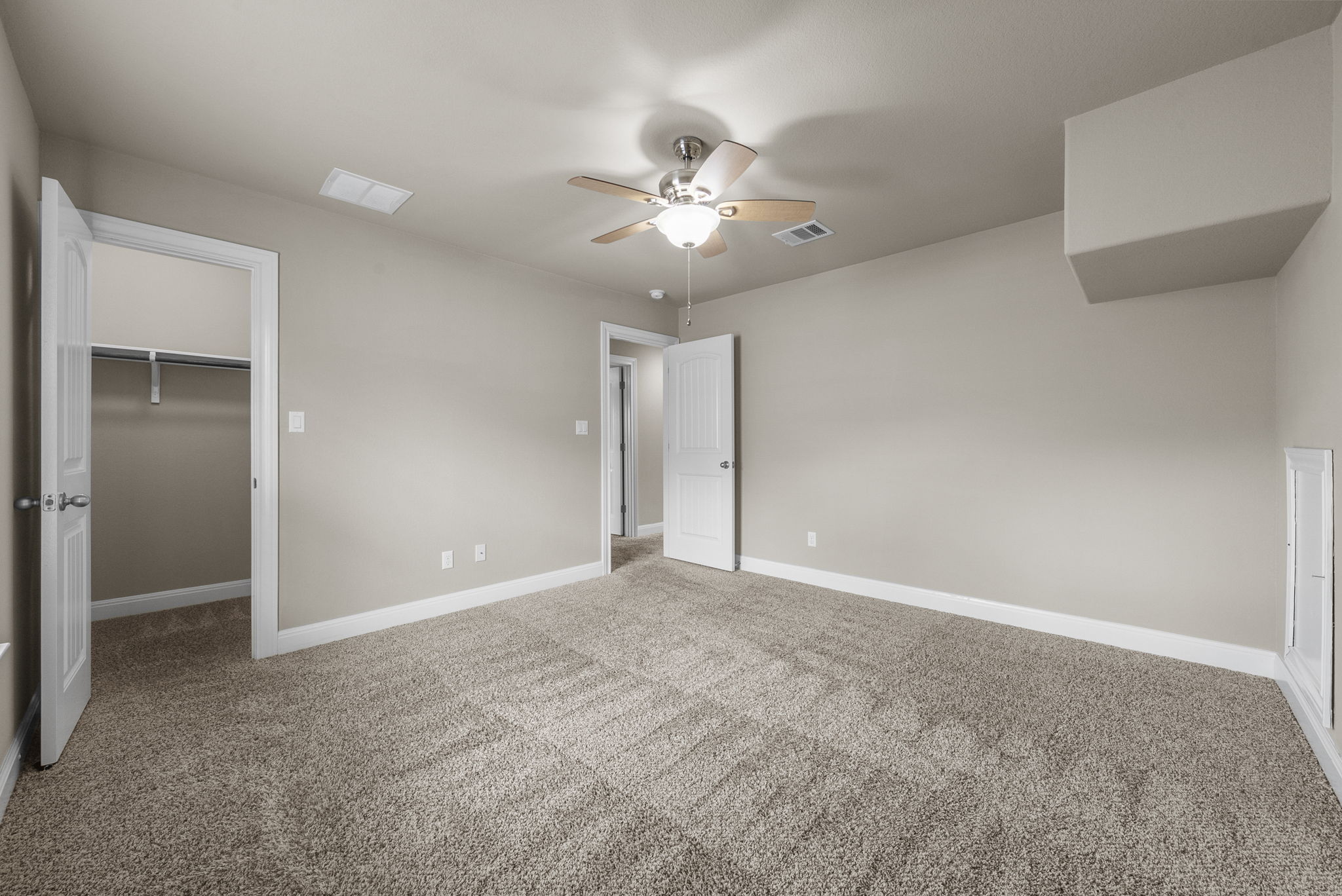 4401 Trinity Woods Street Leander, TX 78641 - Photo 29 of 37 A spacious secondary bedroom offers comfortable carpeting and a convenient walk-in closet.