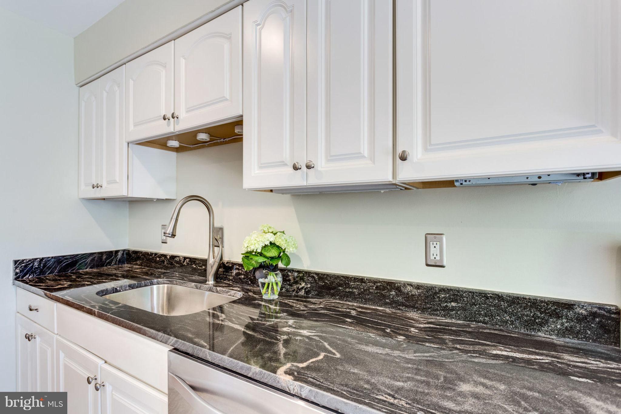 9147 Rockefeller Lane Springfield, VA 22153 - Photo 14 of 30 a kitchen with granite countertop white cabinets and a sink