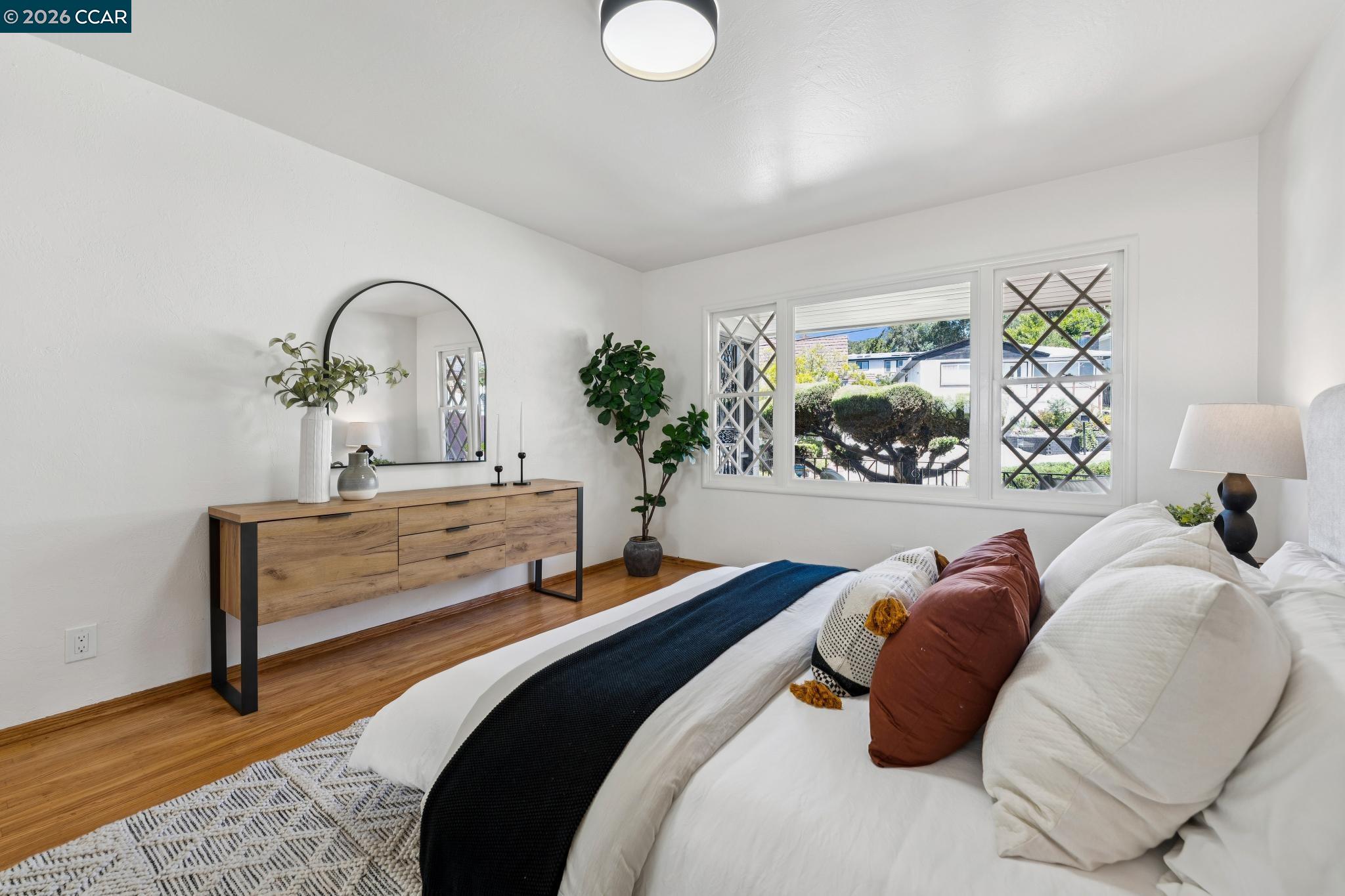 4034 Rusting Avenue Oakland, CA 94605 - Photo 13 of 52 a bedroom with bed and a potted plant