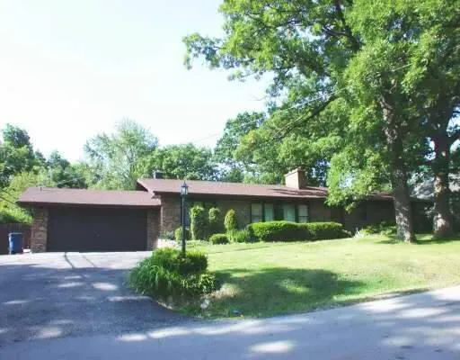 a view of house with yard and green space