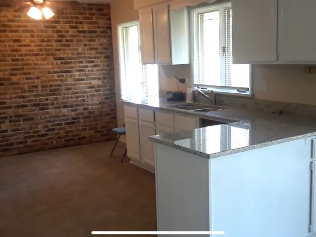 a kitchen with stainless steel appliances a refrigerator and a stove