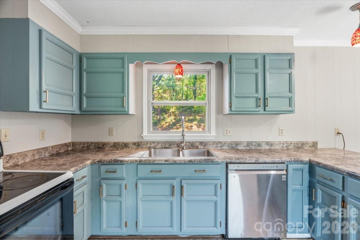 14 Jack Sullins Road Spruce Pine, NC 28777 - Photo 17 of 37 a kitchen with granite countertop a sink stainless steel appliances white cabinets and a window