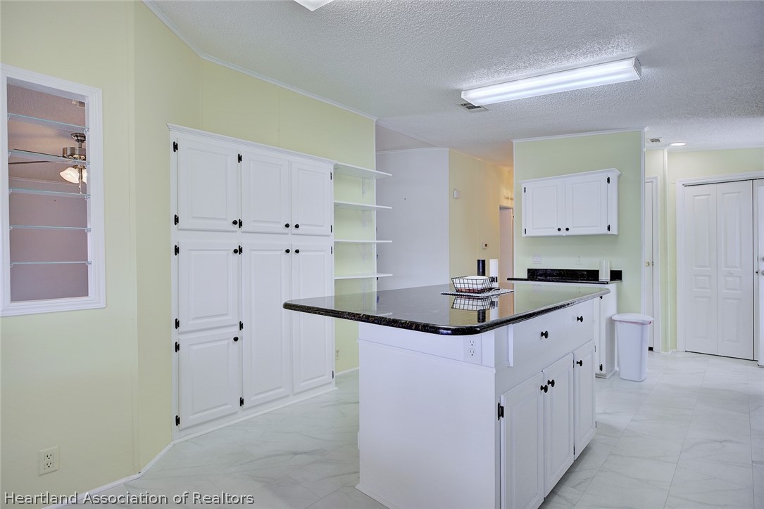 2702 Rodney Street Sebring, FL 33872 - Photo 7 of 33 a kitchen with stainless steel appliances granite countertop a sink and cabinets