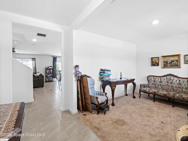 a view of a livingroom with furniture and a bedroom