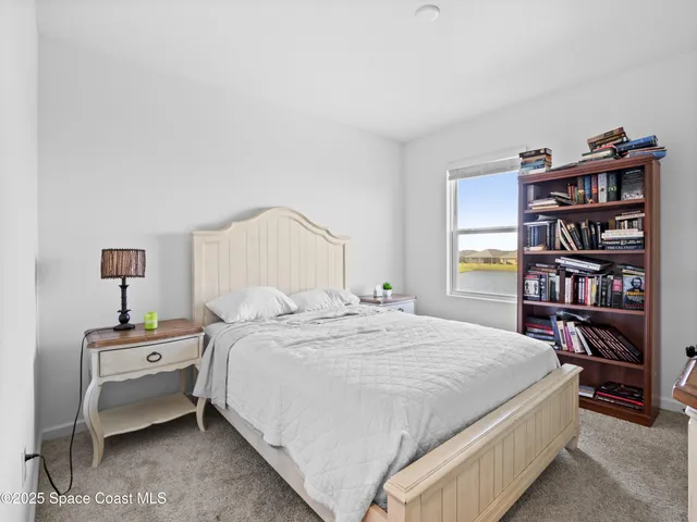 a bedroom with a bed and a book shelf