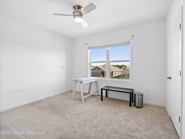 a view of a livingroom with furniture and a window