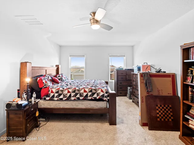 a bedroom with bed and a chandelier