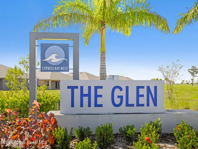 a sign that is in front of flowers