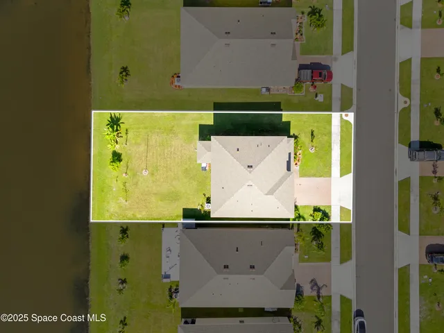 an aerial view of a house with a swimming pool