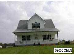 120 Lackey Mountain Road Hiddenite, NC 28636 - Photo 1 of 8 a front view of a house with garden