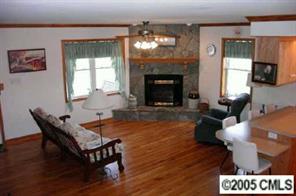 120 Lackey Mountain Road Hiddenite, NC 28636 - Photo 5 of 8 a living room with furniture a flat screen tv and a fireplace
