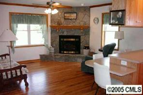 120 Lackey Mountain Road Hiddenite, NC 28636 - Photo 6 of 8 a living room with furniture a fireplace and a flat screen tv