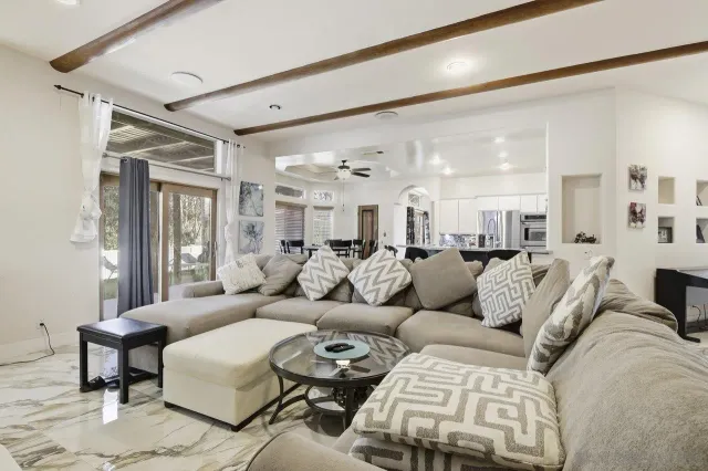 a living room with furniture and a large window