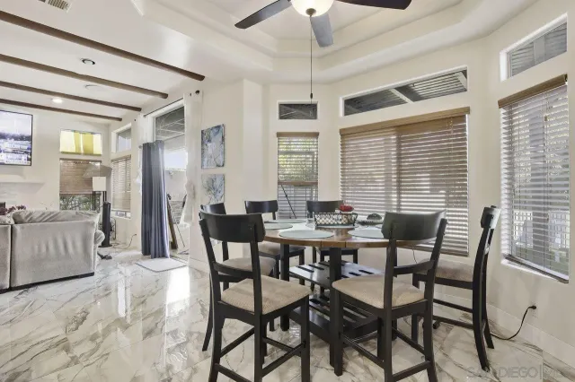 a view of a dining room with furniture and chandelier