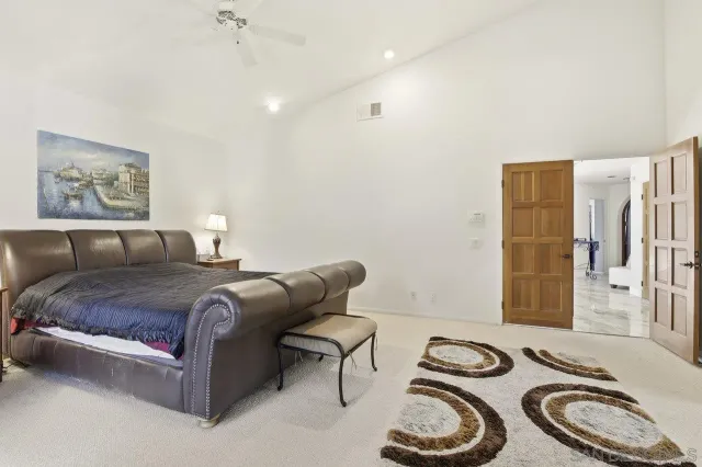 a bedroom with bed and a couch