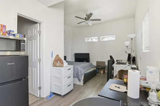 a bedroom with a bed and a view of kitchen