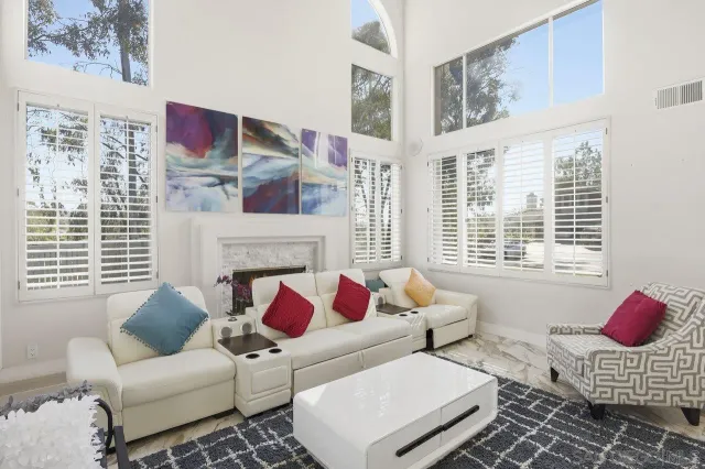 a living room with furniture fireplace and window