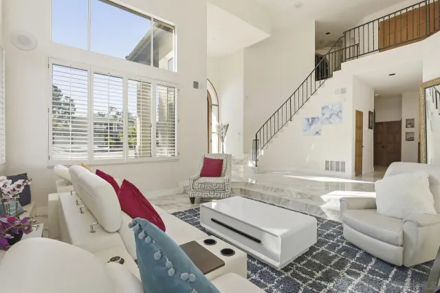 a living room with furniture and a floor to ceiling window