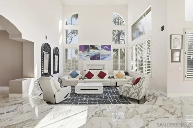 a living room with furniture and painting on the wall