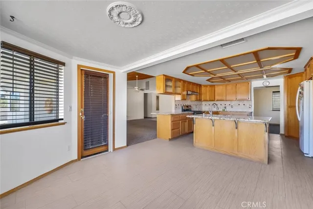 an empty room with fireplace and windows