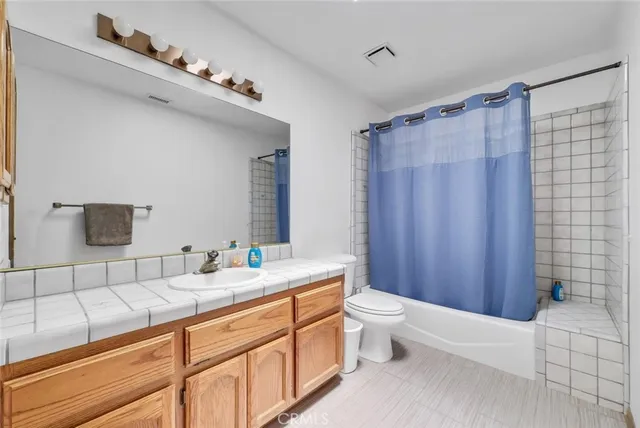 a view of a dry yard with wooden fence